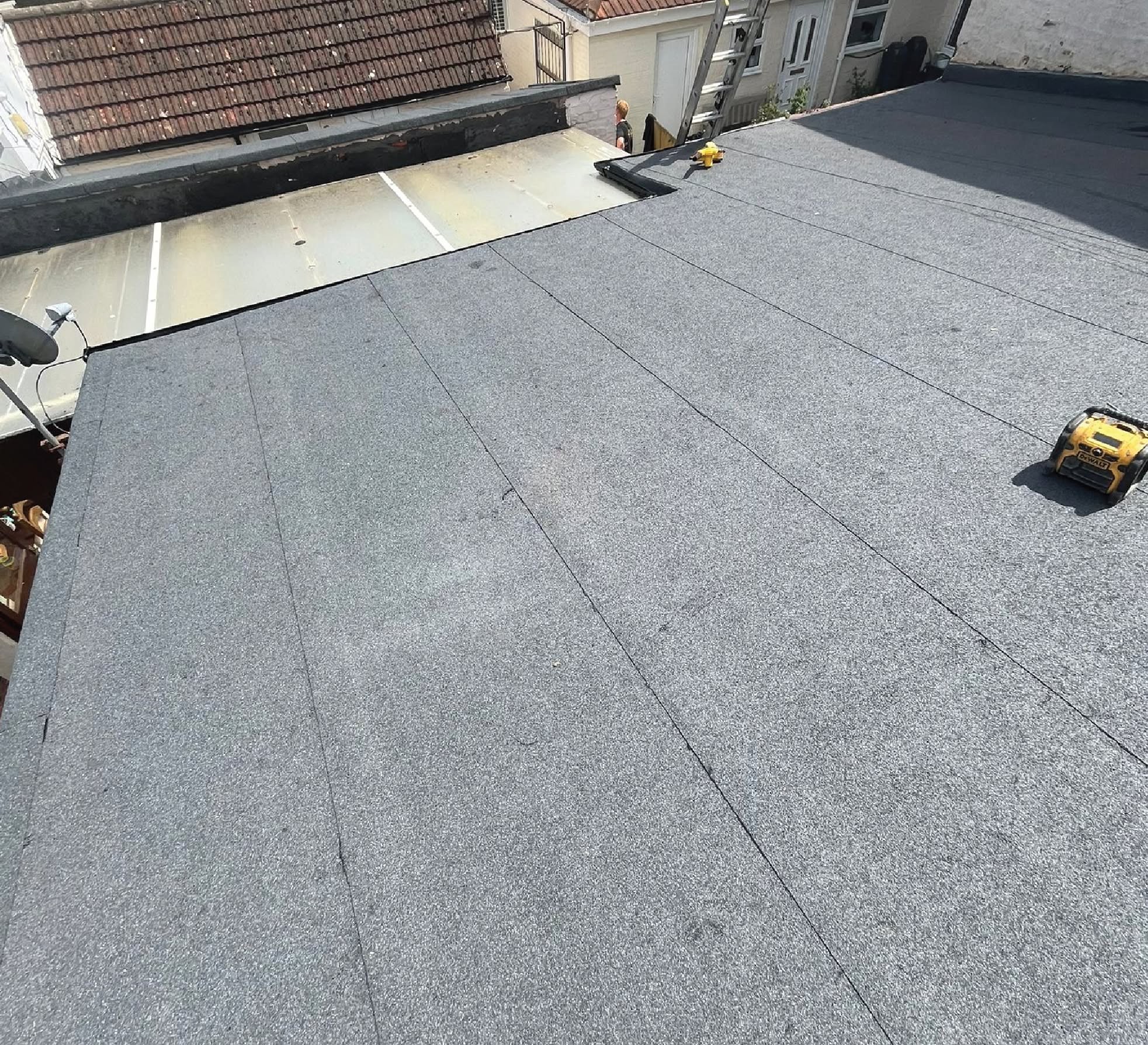 Large EPDM flat roof installation with sealed seams