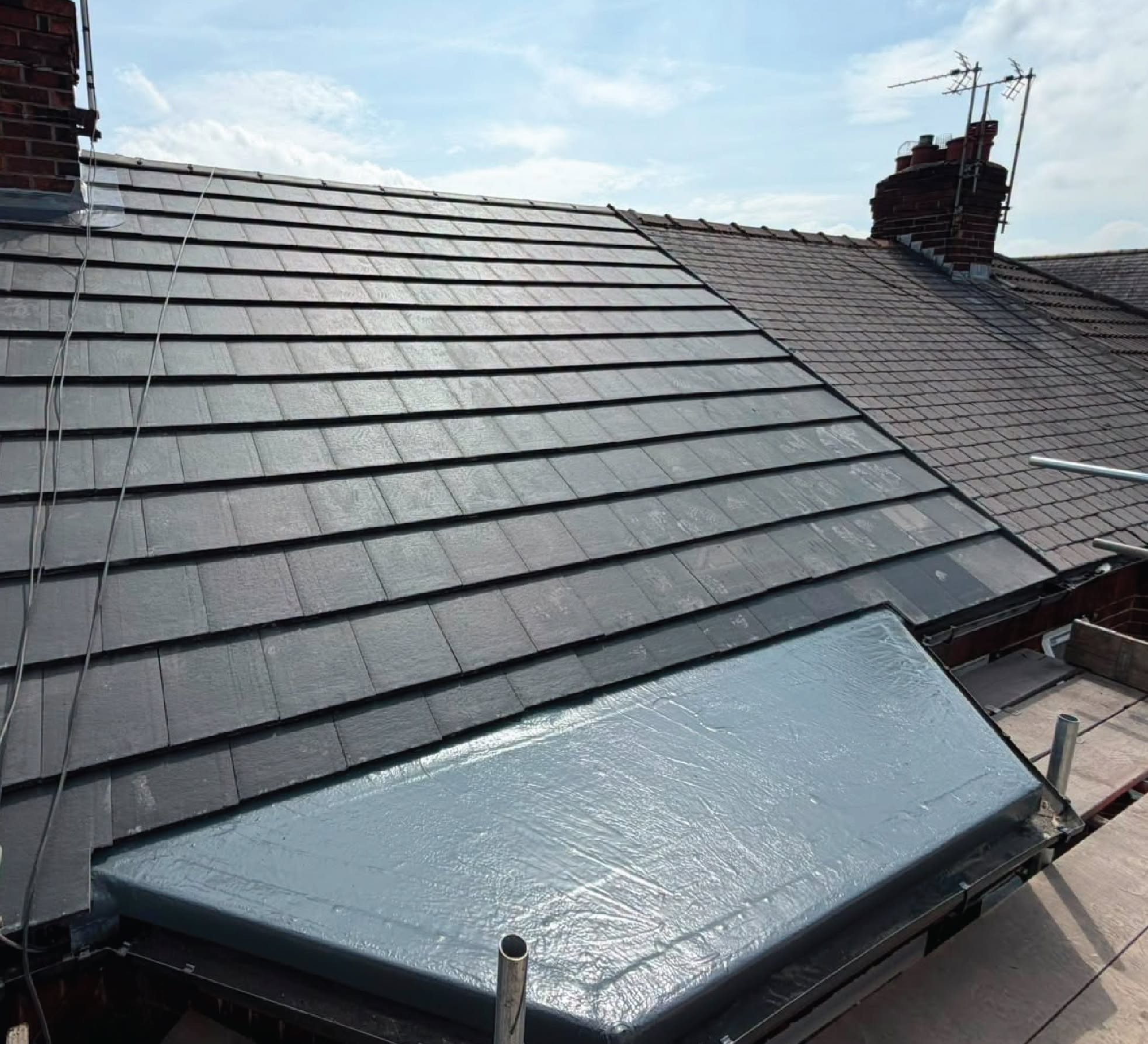 Dark tile roof with sealed flat roof dormer